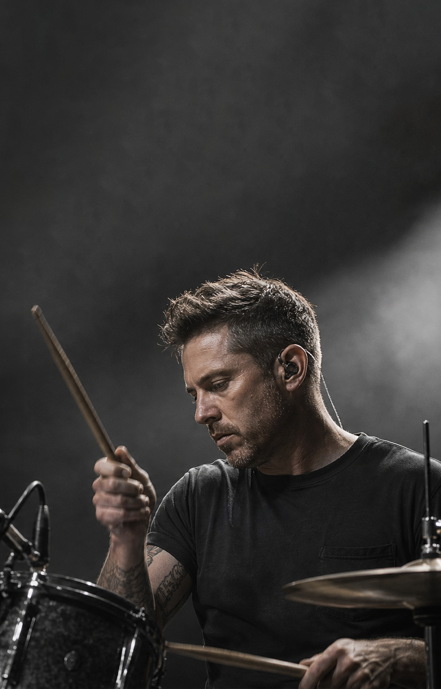 Drummer wearing in-ear monitors on stage