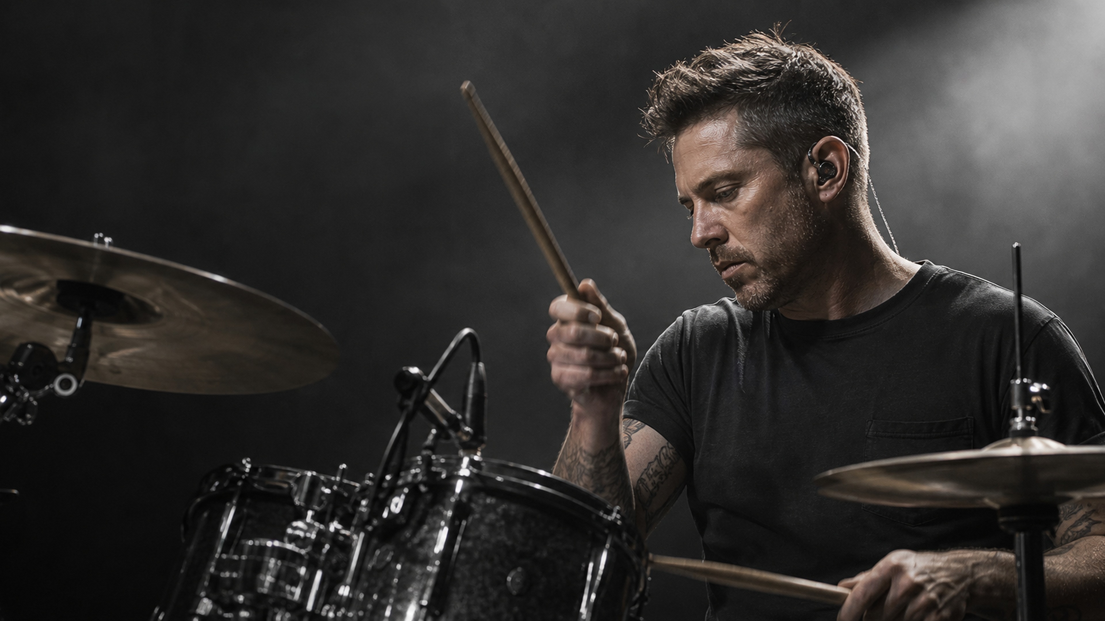 Drummer wearing in-ear monitors on stage