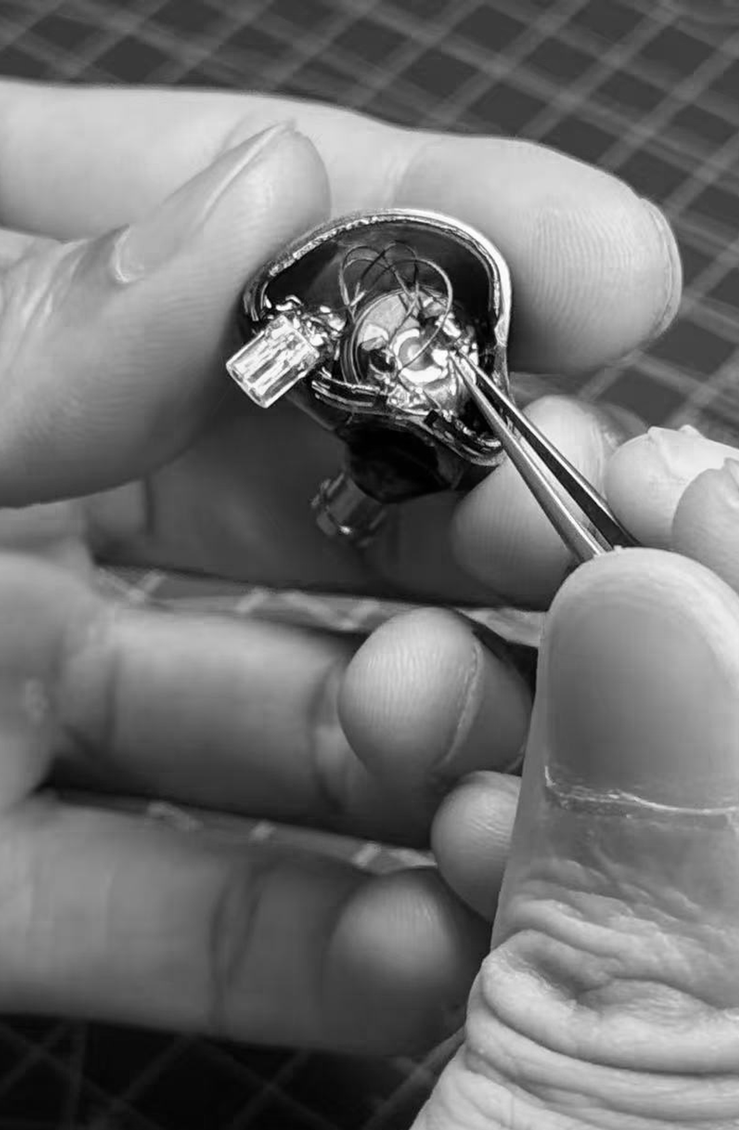 Technician assembling in-ear monitor components
