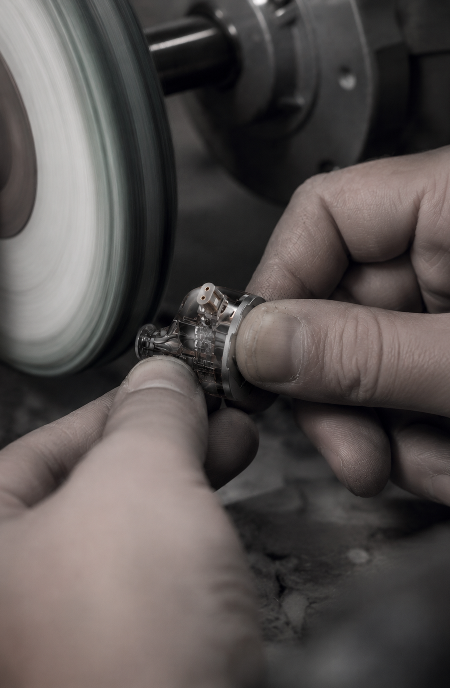 Technician polishing an in-ear monitor shell
